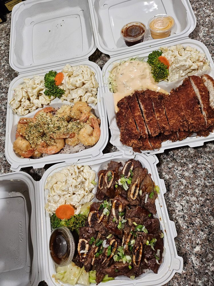 A spread of Burnin' Grill plates including garlic shrimp